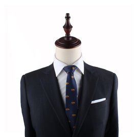A mannequin exudes modern charm, dressed in a dark suit jacket, white shirt, and a stylish Pork Roll Thin Tie against a plain white background.