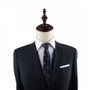 A mannequin exudes modern charm, dressed in a dark suit jacket, white shirt, and a stylish Pork Roll Thin Tie against a plain white background.