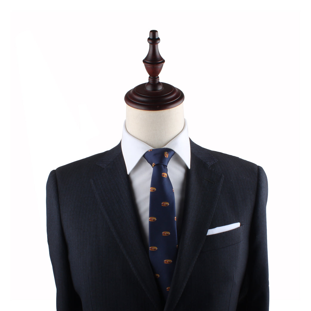A mannequin exudes modern charm, dressed in a dark suit jacket, white shirt, and a stylish Pork Roll Thin Tie against a plain white background.