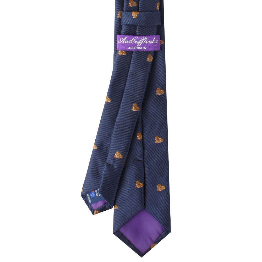 A navy blue Puppy Dog Skinny Tie adorned with small brown heart patterns and a purple label displaying the brand name "Auster Wenks Australia" on the reverse side, perfect for dog lovers who appreciate a touch of warmth in their attire.