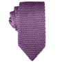 A rolled-up Classic Purple Knit Tie with modern flair on a white background.