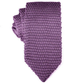A rolled-up Classic Purple Knit Tie with modern flair on a white background.