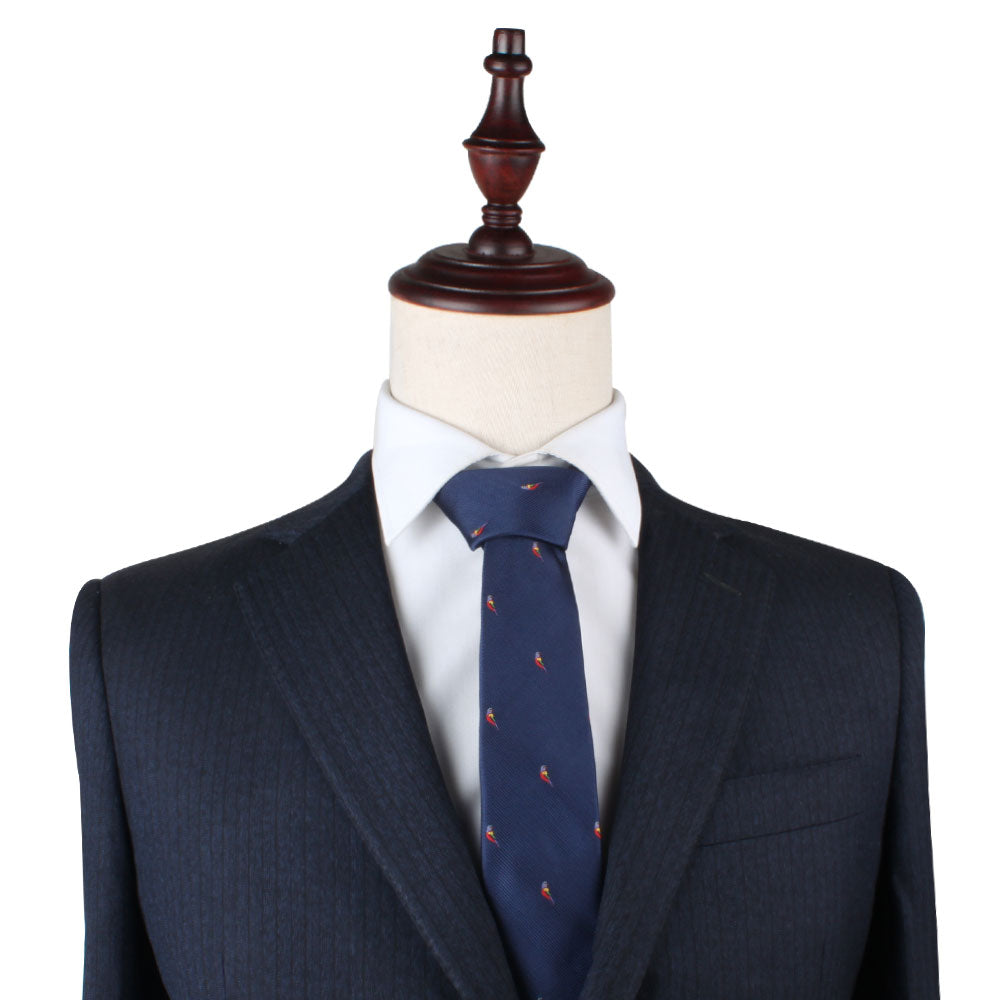 A mannequin dressed in a navy blue suit with a Red Parrot Slim Tie.