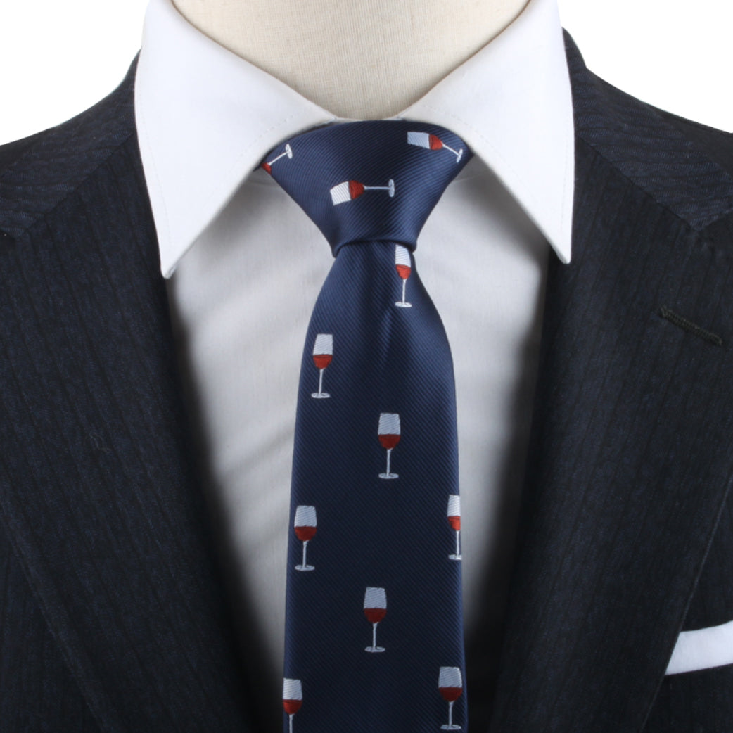 A person exudes modern charm in a dark suit, complemented by a crisp white shirt and the Red Wine Necktie, featuring a wine glass pattern that showcases refined taste.