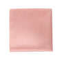 The Rose Gold Pocket Square, set against a pristine white backdrop, exudes elegance and refinement with its intricate folds.