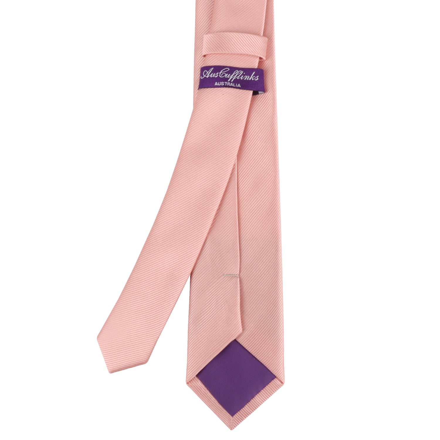 The Rose Gold Skinny Necktie, adorned with a subtle diagonal pattern, exudes timeless elegance, featuring a purple label on the back reading "Just Cufflinks Australia.