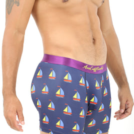 A person savoring the comfort of Sail Boat Underwear, featuring a sailboat pattern on blue boxer briefs with a stylish purple waistband, setting them adrift on waves of fashion.