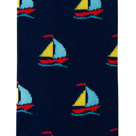 Close-up of the dark blue Sailing Socks featuring a repeated pattern of small, colorful sailboats, evoking the comfort one feels while sailing on gentle waves.