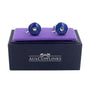 Introducing the Sapphire Blue Cufflinks: a pair of round cufflinks in deep blue with a silver center, elegantly presented on a black box with a purple padded top, and labeled "AUSCUFFLINKS".