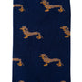 A pair of Sausage Dog Socks featuring a quirky repeating pattern of small, stylized canine figures in yellow and brown on a blue background.