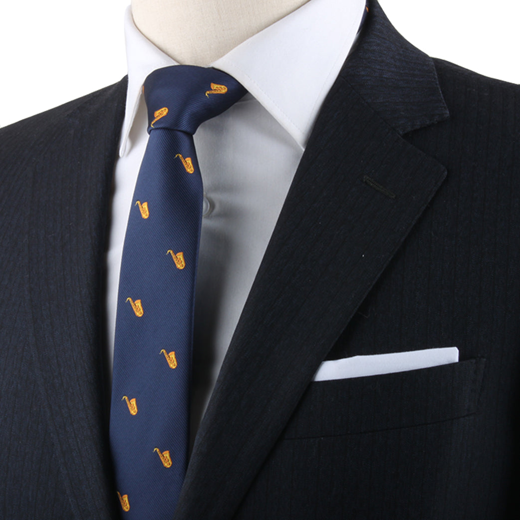 Sax Tie adorned with musical elegance through yellow patterns, displayed on a mannequin donning a redefined dark blazer and a white pocket square.