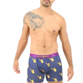 A man with a beard and a tattoo on his shoulder is modeling Saxophone Boxer, giving off cool vibes down under.