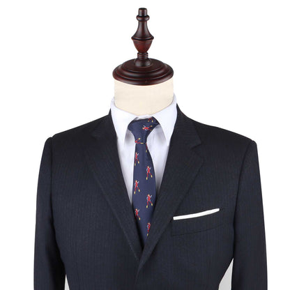 A stylish dark gray pinstripe suit on a wooden mannequin, featuring a white dress shirt, the Scuba Diver Slim Tie in blue, and a white pocket square that adds an element of intrigue.