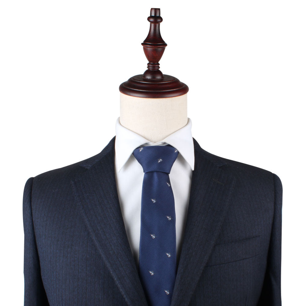 A mannequin dressed in an elegant dark pinstripe suit and crisp white dress shirt is showcased with the Great White Shark Skinny Tie, which features a subtle white shark motif, all set against a plain white background.