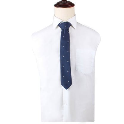 A mannequin elegantly displays a white dress shirt adorned with the Great White Shark Skinny Tie, featuring an intriguing blue pattern with a white shark motif.