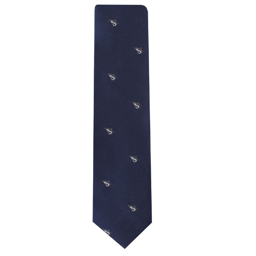 The Great White Shark Skinny Tie is a solid navy blue necktie adorned with small embroidered letters and an elegant white shark motif scattered throughout.