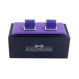 Presented on an "AUSCUFFLINKS" black box, the Midnight Purple Cufflinks boast a blue striped design on a purple cushion. Perfect for the stylish gentleman, they epitomize sophistication and make an excellent addition to any Midnight Purple outfit.