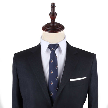 A dark suit paired with the Skateboarder Slim Tie, featuring subtle patterns, exudes confidence on a mannequin, set against a plain background.