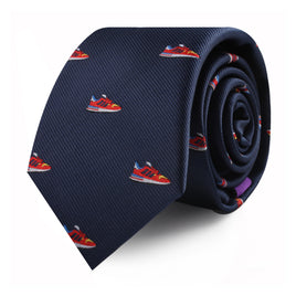 A Sneaker Skinny Tie with small red and white sneaker motifs rolled up, showcasing modern style with a touch of urban flair.