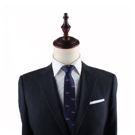 A black mannequin dressed in a dark suit, white dress shirt, and a Sneaker Slim Tie exudes modern style and urban flair.