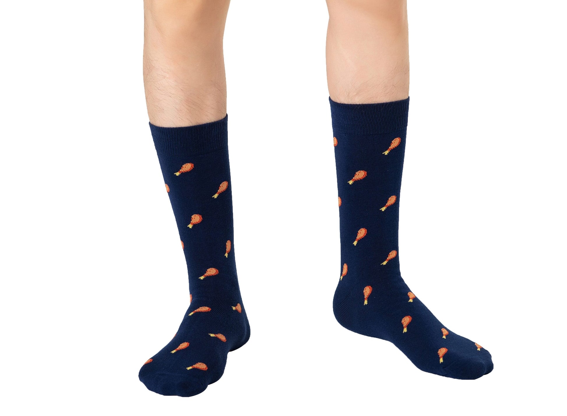 Person showcasing a layered style with knee-high navy Strawberry Cake Socks featuring an orange drumstick pattern.
