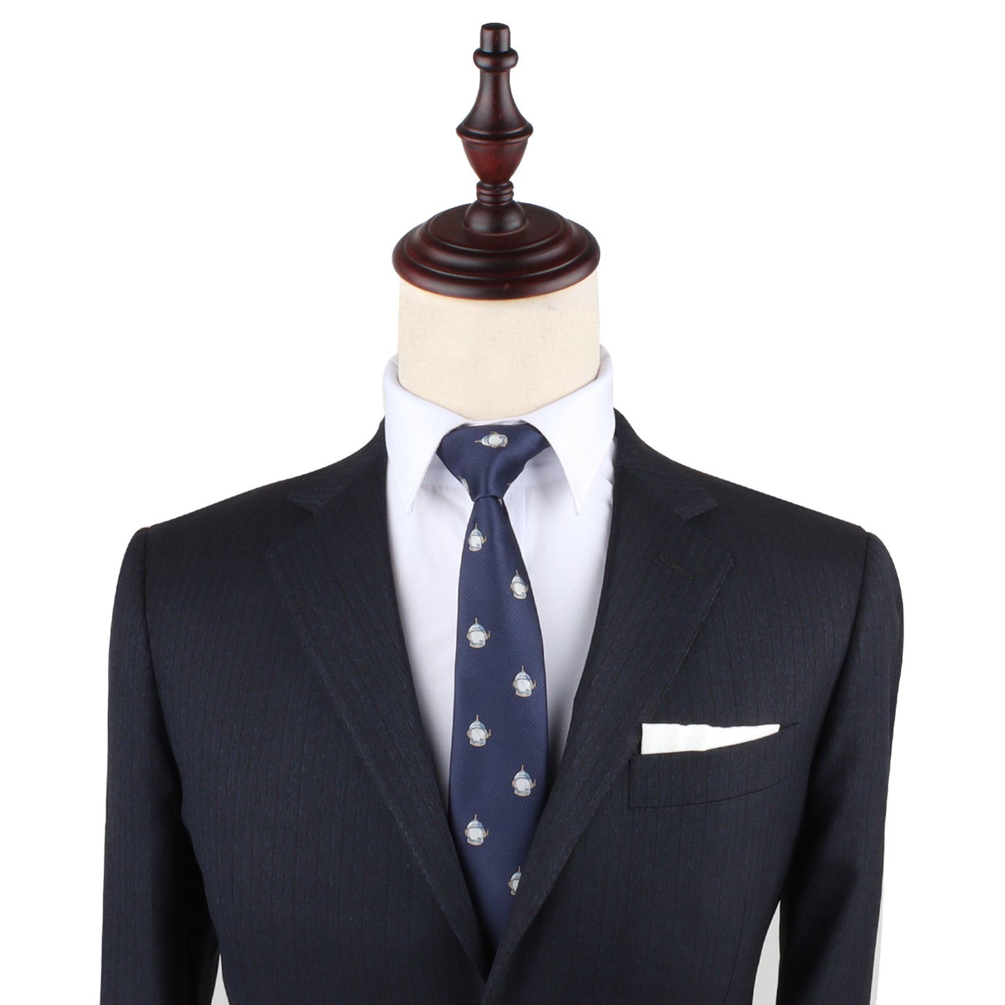 A tailored black suit on a mannequin, paired with a white dress shirt, the Spaceman Slim Tie adorned with small white crests, and a white pocket square elegantly elevate your style to celestial levels.