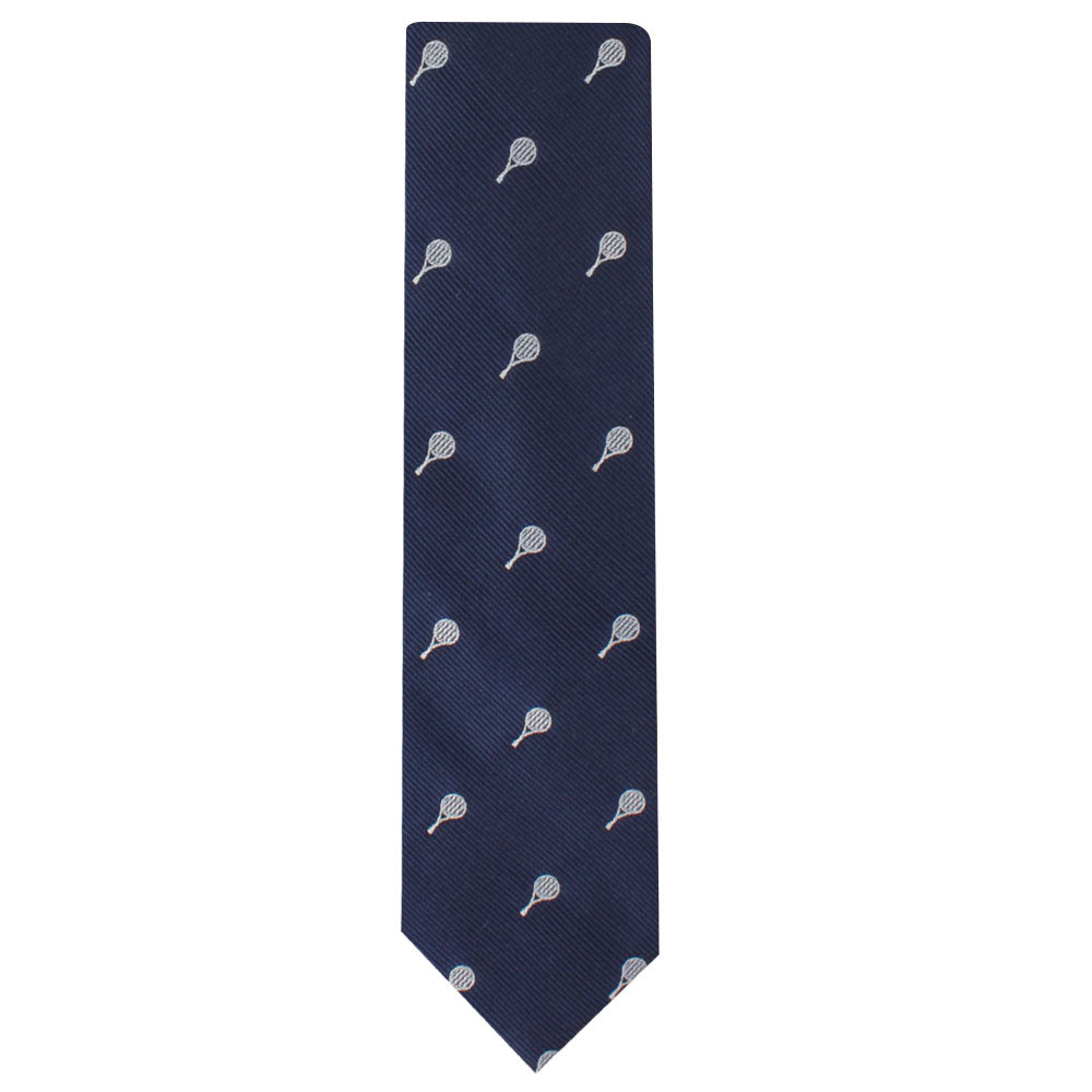 The Sports Skinny Tie is a navy blue necktie adorned with a pattern of small white tennis rackets evenly spaced across its surface, exuding athletic elegance and timeless refinement.