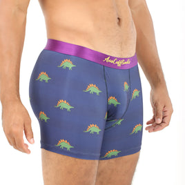 A man in Stegosaurus Underwear with a purple waistband stands against a white background, highlighting the dino-sized snugness of his stylish garment.