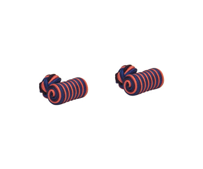 Two coiled hair ties with alternating purple and pink stripes create a stunning harmony of hues against a plain white background.