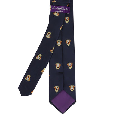 Stylish Dog Tie featuring a playful pattern of dog faces with a purple lining, ideal for pet lovers who enjoy fun fashion accessories.