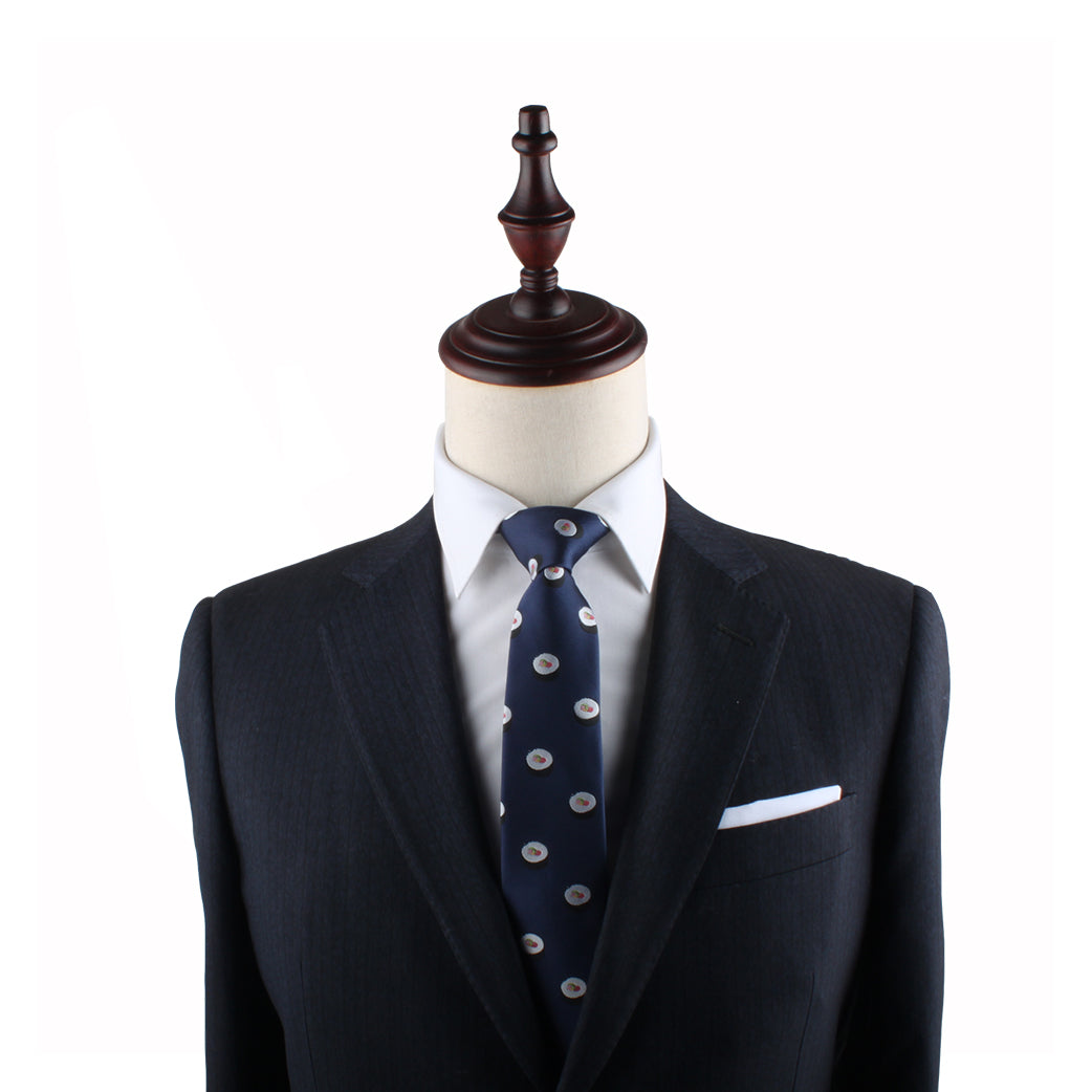 A headless mannequin exudes modern charm in a dark suit, white dress shirt, and the Sushi Slim Tie against a plain white background.