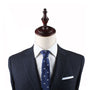 Navy suit and Swimming Slim Tie, evoking timeless style, displayed on a mannequin torso.