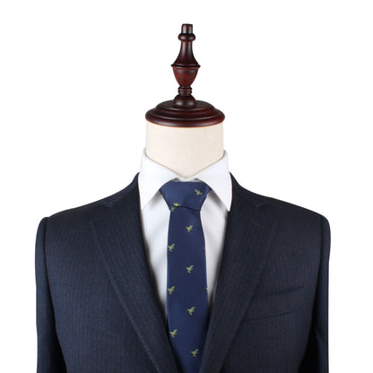 A mannequin displays a dark pinstriped suit with a matching jacket and trousers. It is dressed with a white shirt and a T-Rex Dinosaur Skinny Tie, perfect for dinosaur enthusiasts.