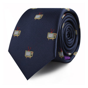 The TV Skinny Tie is a rolled navy blue necktie featuring a pattern of small, vintage television illustrations, adding an elegant touch to any entertainment enthusiast’s wardrobe.