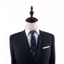 A dark suit jacket and tie on a mannequin with a wooden top, exuding modern style. The suit features a crisp white dress shirt underneath and a Taco Slim Tie in the breast pocket, creating an ensemble that's much like a sartorial Mexican delight.