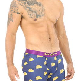 A shirtless man wears the Taco Underwear, featuring navy blue boxer briefs with a taco pattern. They're perfect for taco lovers seeking moisture-wicking comfort and style in one fun package.