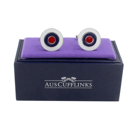 Circle Target Cufflinks with red and black bullseye centers come elegantly displayed on a purple cushion inside a black box labeled "AUSCUFFLINKS," ideal for elevating formal or business attire.