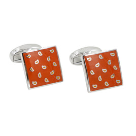 The Tear Drop Orange Cufflinks are a pair of silver square cufflinks with an orange face, adorned with small white droplet shapes, perfect for adding zest to your formal attire.