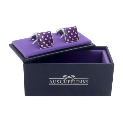 A pair of Tear Drop Purple Cufflinks, exuding an air of elegance, displayed on and adjacent to a lavish purple velvet-lined box labeled "AUSCUFFLINKS.