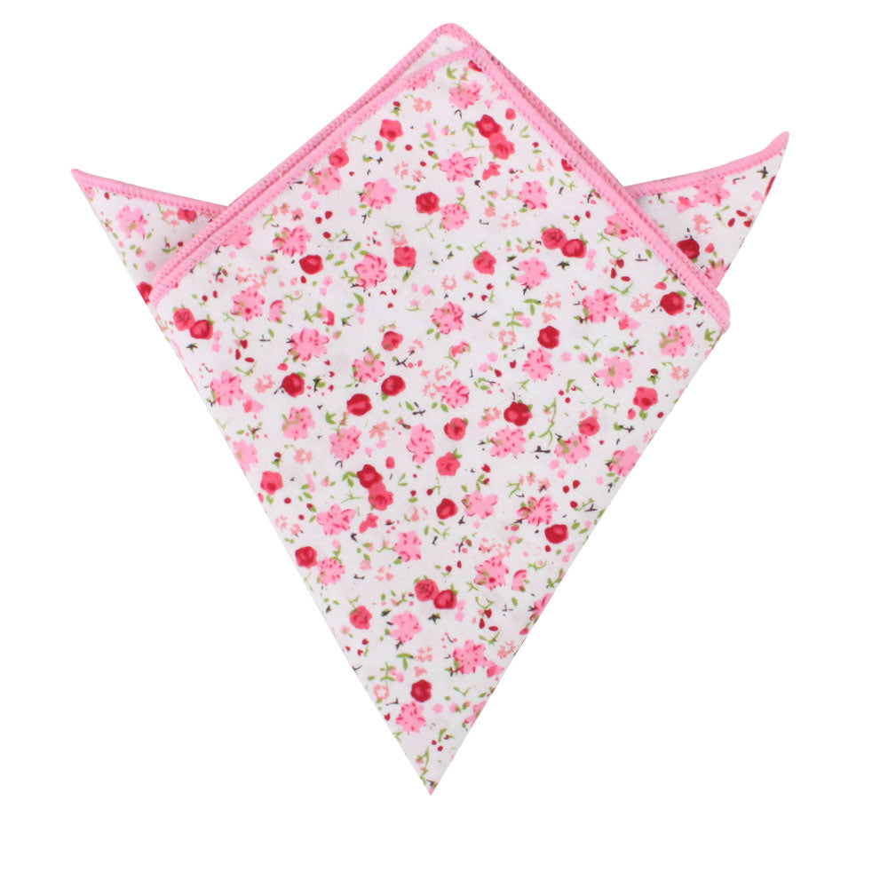 A triangular-folded pocket square featuring a floral azalea pattern with pink edges from the Tonal Pink Azalea Floral Cotton Skinny Tie & Pocket Square Set.
