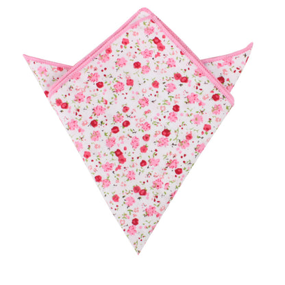 A triangular-folded pocket square featuring a floral azalea pattern with pink edges from the Tonal Pink Azalea Floral Cotton Skinny Tie & Pocket Square Set.