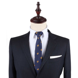 Navy blue suit with Treasure Chest Slim Tie and white pocket square displayed on a headless mannequin, designed as attire for any uncover adventure.