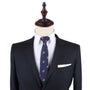 Navy blue suit with Treasure Chest Slim Tie and white pocket square displayed on a headless mannequin, designed as attire for any uncover adventure.