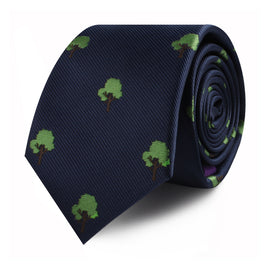 The Tree Skinny Tie, featuring small green tree motifs on a navy blue background, captures the allure of nature in timeless fashion.