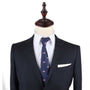 A mannequin dressed in a dark suit with a white shirt and the USA Flag Slim Tie, exuding a sense of patriotism and style, completed by a crisp white pocket square.