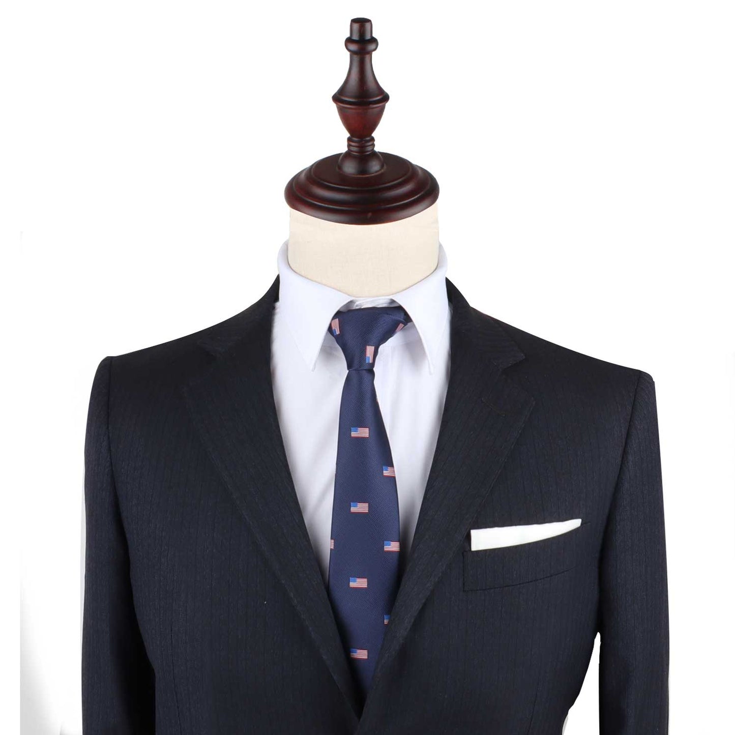 A mannequin dressed in a dark suit with a white shirt and the USA Flag Slim Tie, exuding a sense of patriotism and style, completed by a crisp white pocket square.