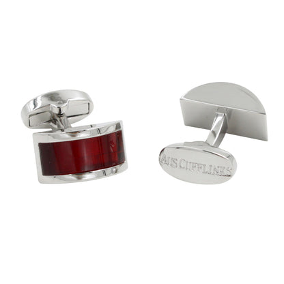 A pair of Ruby Stone Red Cufflinks with red inlay detail exude gem-like brilliance. One cufflink is positioned upright, while the other lies flat, showcasing an engraved oval back—a perfect accessory for a gentleman.