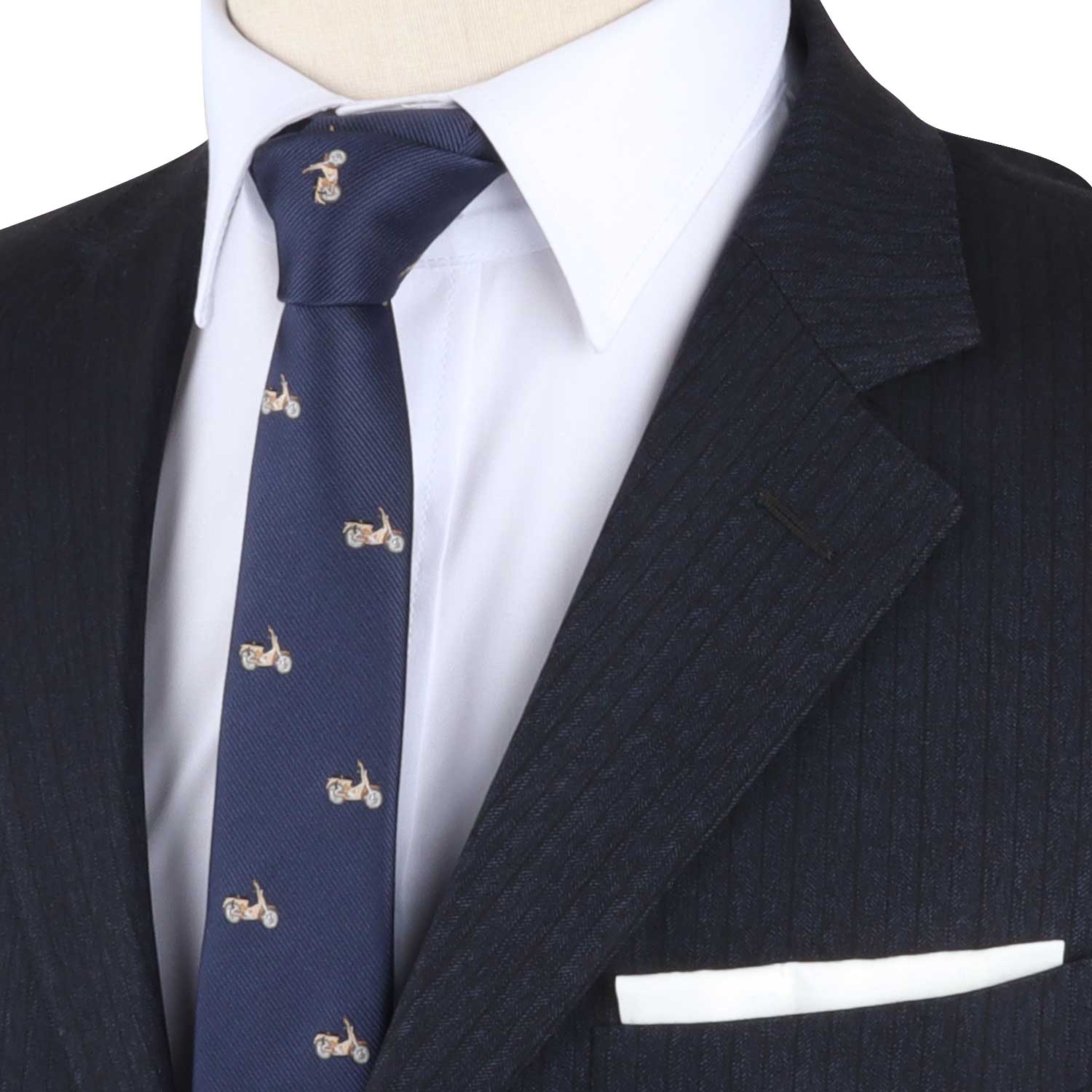 The mannequin is dressed in a dark pinstripe suit, white shirt, and the Vintage Motorcycle Tie, which is adorned with small motorcycle patterns and exudes an air of elegance that seamlessly combines the sophistication of fashion with the excitement of the fast lane.