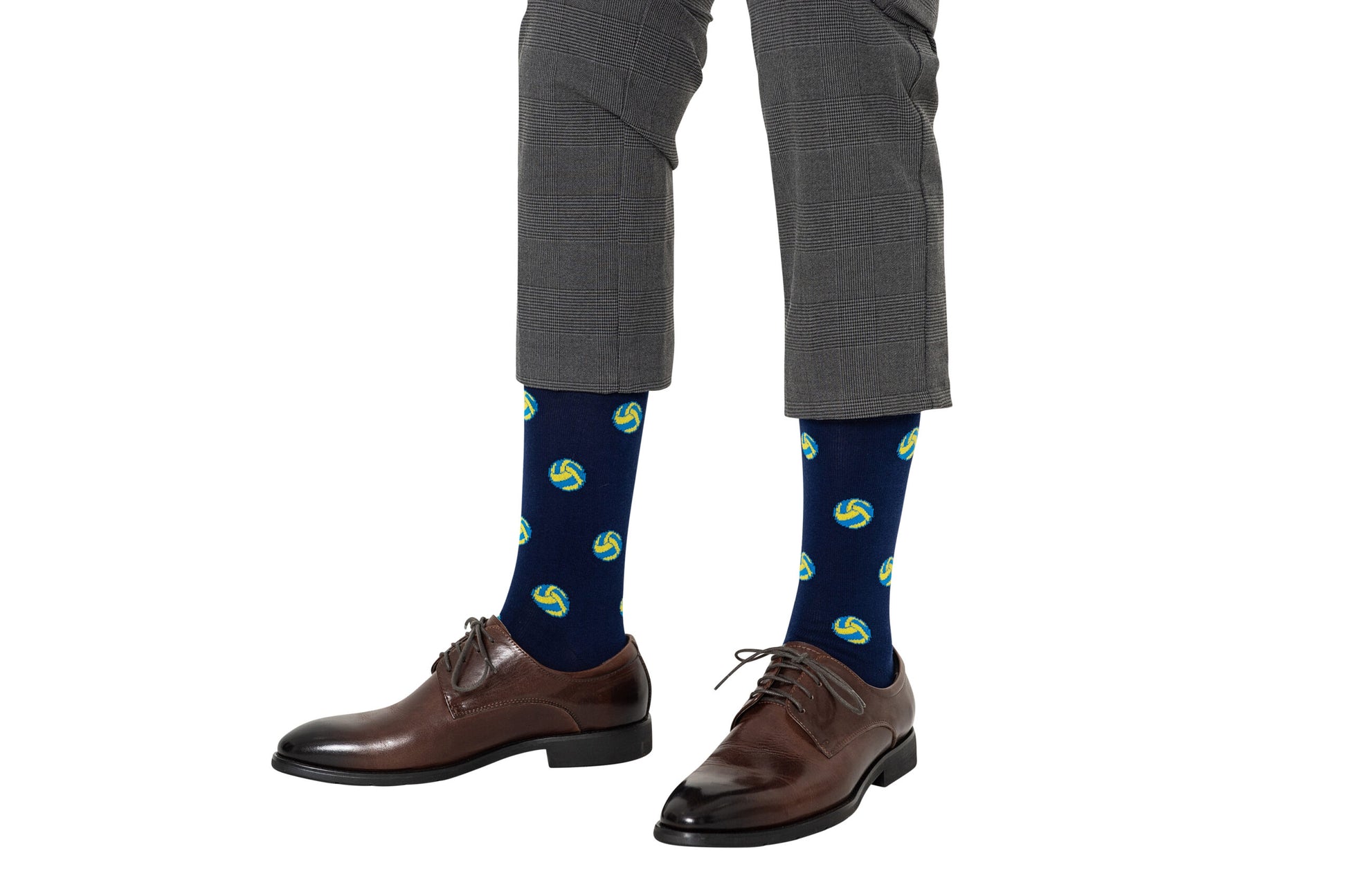 Person wearing gray dress pants, Volleyball Socks with colorful patterns that really elevate their sock game, and brown dress shoes.