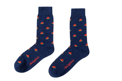 A pair of Watermelon Socks with small red and green watermelon patterns, bringing juicy joy to your outfit, and text that reads "Ladies & Gentlemen,..." on the sole.